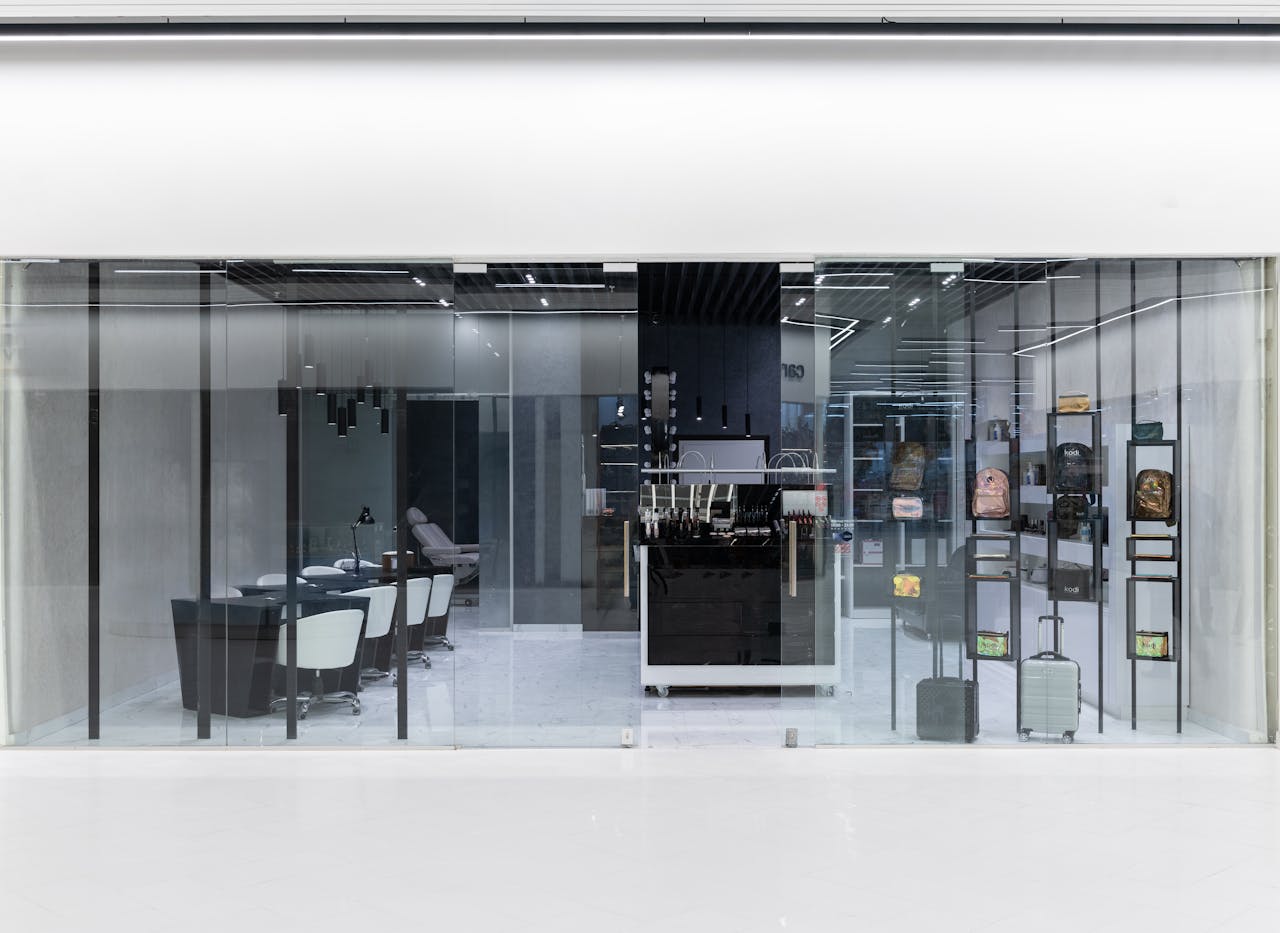 services-01 Sleek interior of a modern store with glass facade, stylish furniture, and display items.
